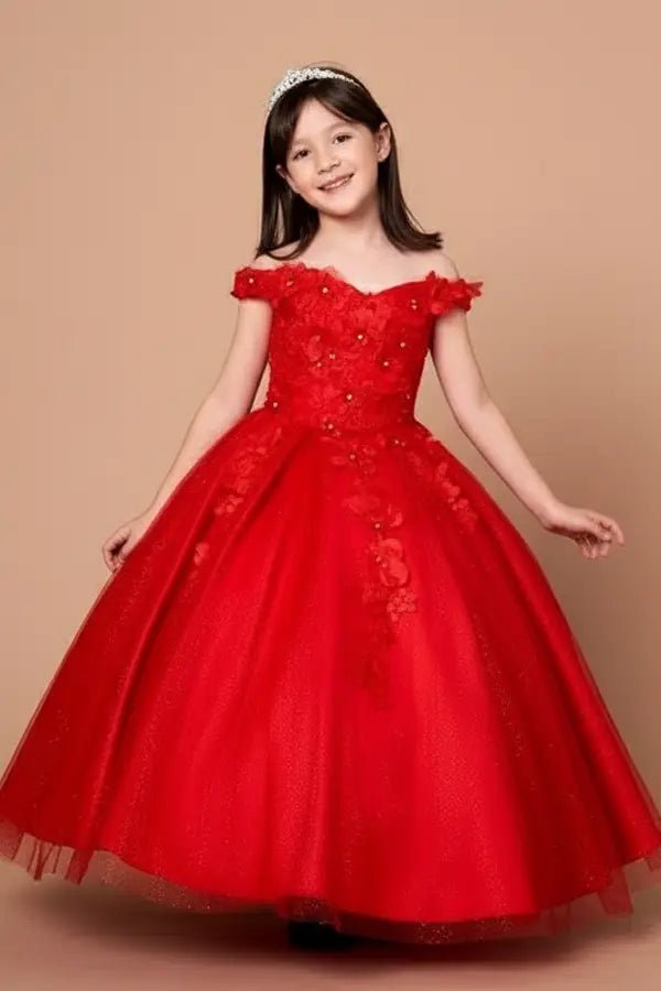 Kid standing front-facing in stunning red ball gown with 3D floral appliqué bodice, glitter accents, and voluminous full-length skirt