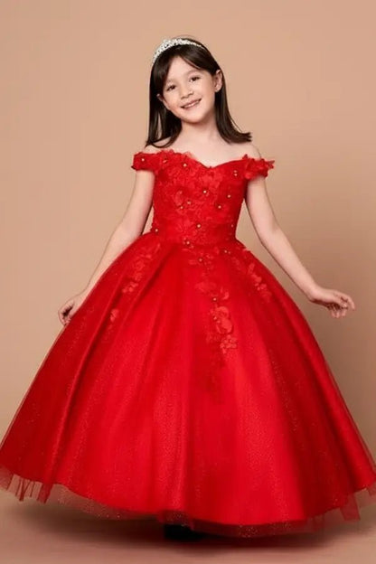 Kid standing front-facing in stunning red ball gown with 3D floral appliqué bodice, glitter accents, and voluminous full-length skirt