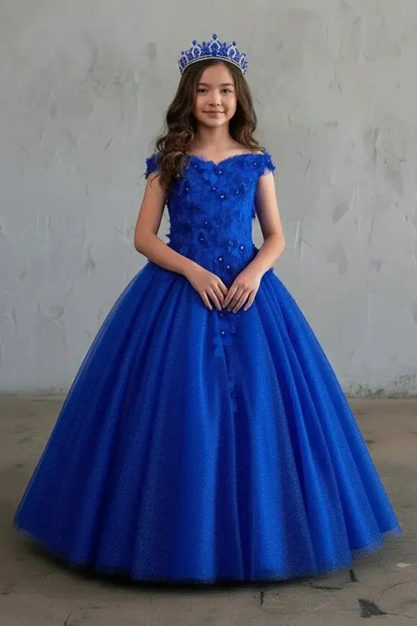 Kid standing front-facing in stunning red ball gown with 3D floral appliqué bodice, glitter accents, and voluminous full-length skirt