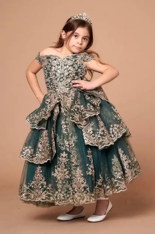 Kid standing front-facing in elegant emerald and gold ball gown with embroidered layered bodice and voluminous full skirt