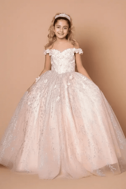 Kid standing front-facing in blush ball gown with 3D floral appliqué bodice, glitter accents, and voluminous full-length skirt