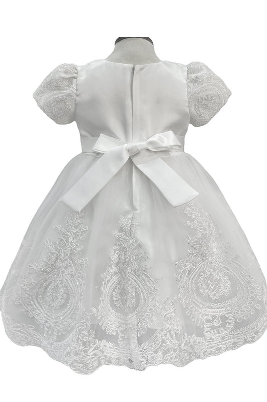 White lace dress with a bow on a mannequin against a white background