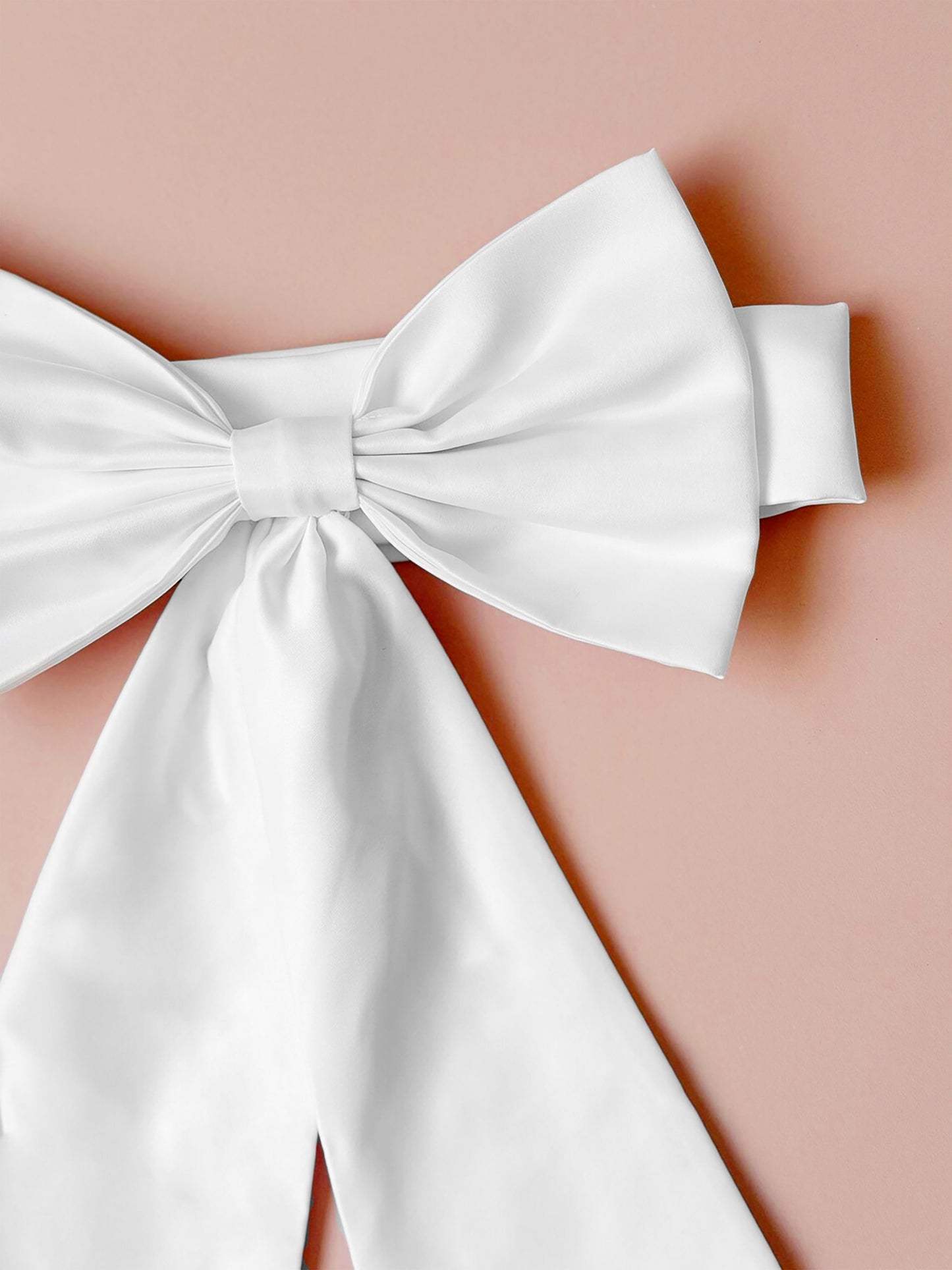 White bow on a pink background